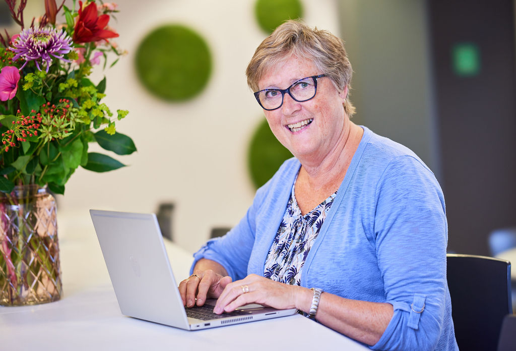 Female behind laptop working 