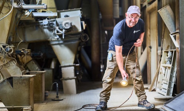 man taking sample in silo