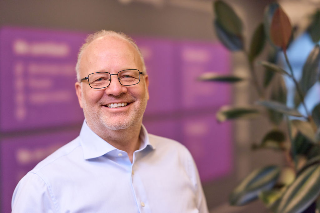 Man with glasses standing in an office